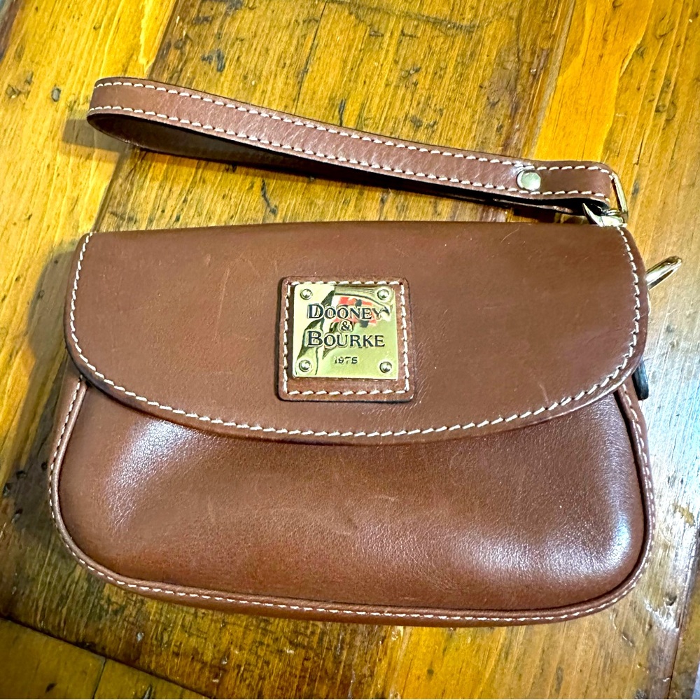 Dooney & Bourke brown leather wristlet with contrast stitching